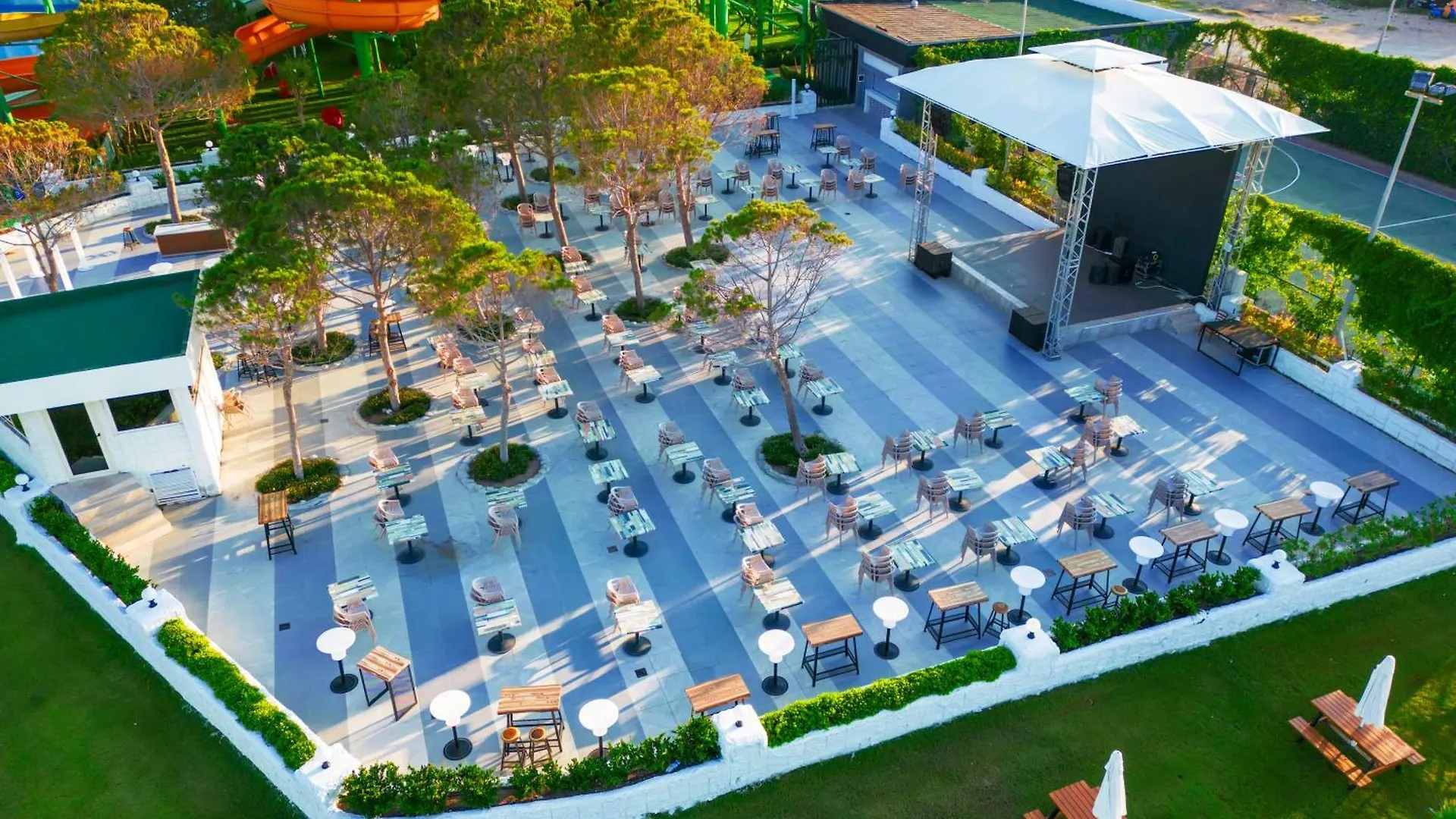 Crystal Centro Pearl Collection Hotel Antalya Exterior photo This is a high-angle, aerial photograph showcasing a large, modern outdoor leisure area, likely part of a resort or entertainment complex.

**Key elements in the photo include:**

*   **The Central Area:** The main space is a vast, paved plaza design